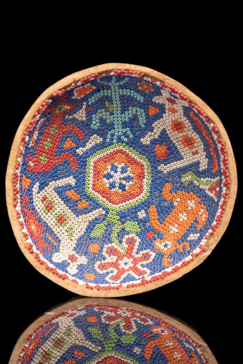 Gourd Covered with Beads with a peyote symbol at the center and two male deer and two female deer around it. It also has a flower and the corn symbol. Indigenous Huichol Art
