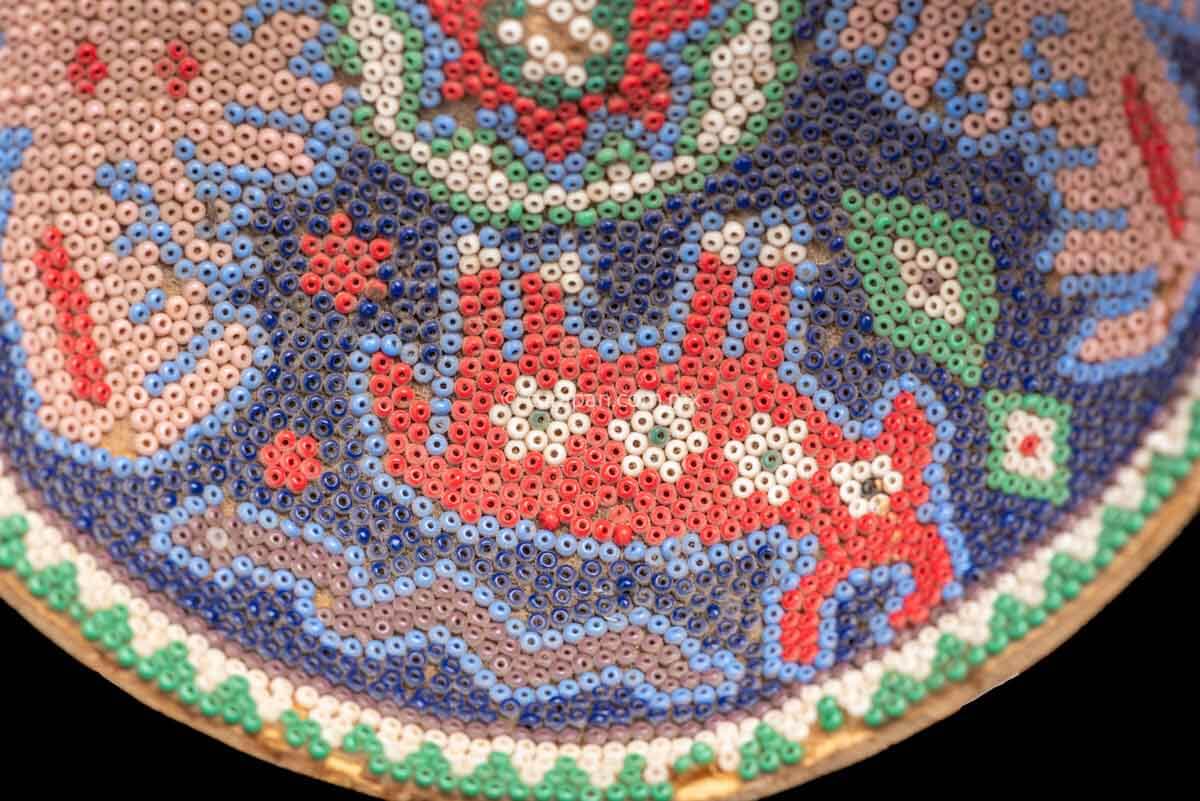 Huichol Gourd covered with beads with peyote symbol at teh center and four sacred animals around it. Such as Eagles & a bull.  Some beads are missing, this is a vintage item. 