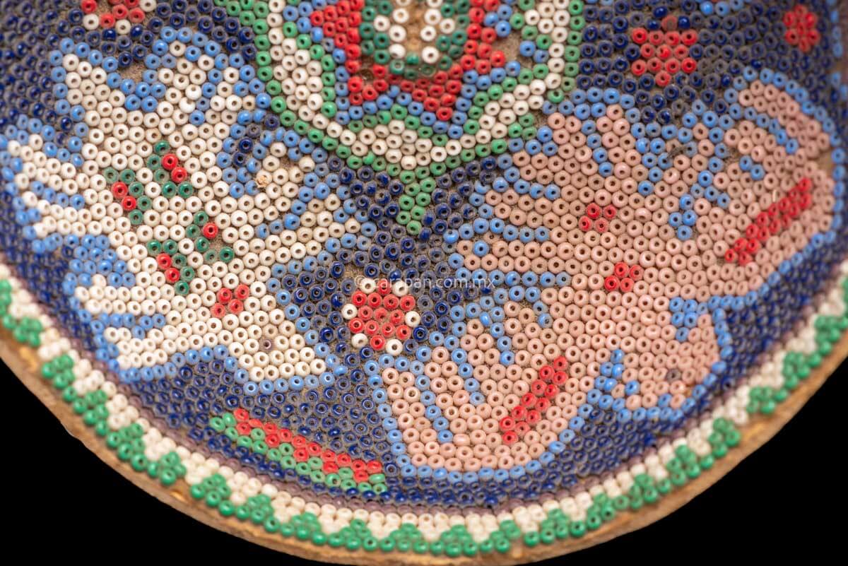 Huichol Gourd covered with beads with peyote symbol at teh center and four sacred animals around it. Such as Eagles & a bull.  Some beads are missing, this is a vintage item. 