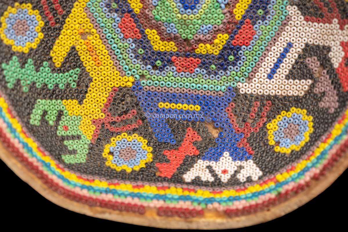 Vintage Huichol Beaded Gourd with Peyote Symbol at the center and 6 deer around it. Crafted with glass beads applied to the gourd over a layer of bees wax with no previous design.