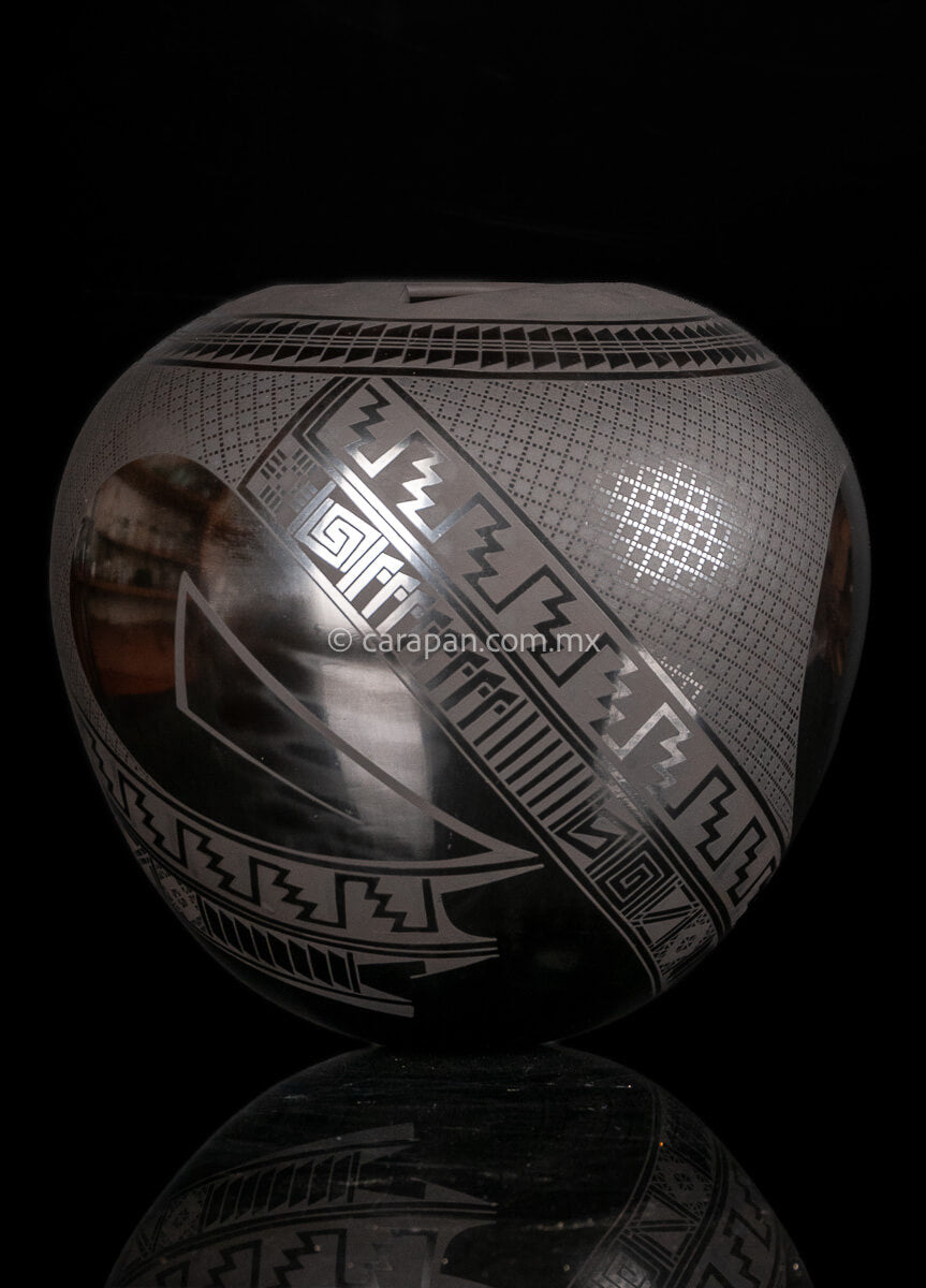 Round shaped Mata Ortiz Pot decorated with black Matte Geometric patterns over black matte burnished clay.