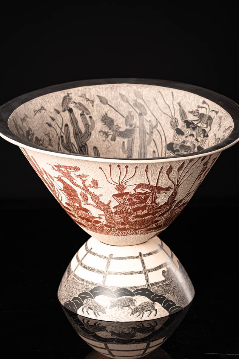 Mata Ortiz pot conic shape decorated with Mexican semi desert & Mountain creatures such as eagles, deer, rams, bats, owls, turkeys, squirrels and bears. The outside of the pot is decorated in brown over beige and the inside in black over beige. The base is also decorated in black over beige with sgraffito technique