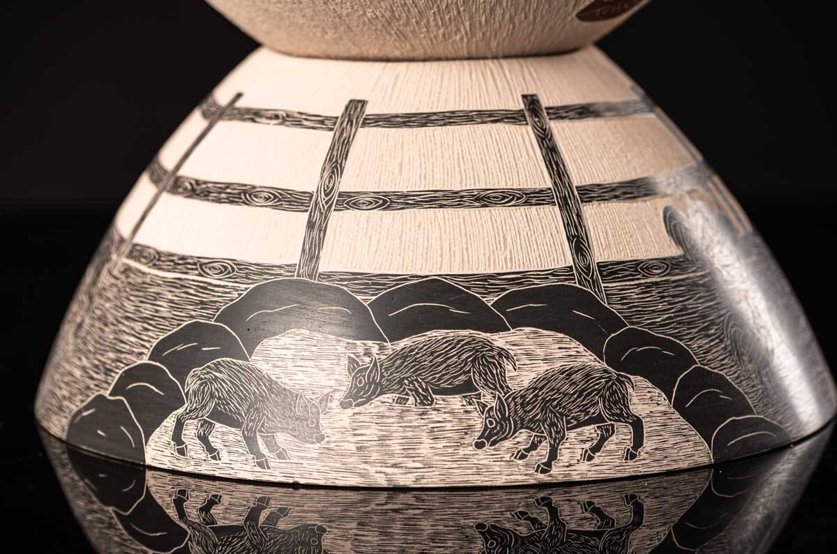 Mata Ortiz pot conic shape decorated with Mexican semi desert & Mountain creatures such as eagles, deer, rams, bats, owls, turkeys, squirrels and bears. The outside of the pot is decorated in brown over beige and the inside in black over beige. The base is also decorated in black over beige with sgraffito technique