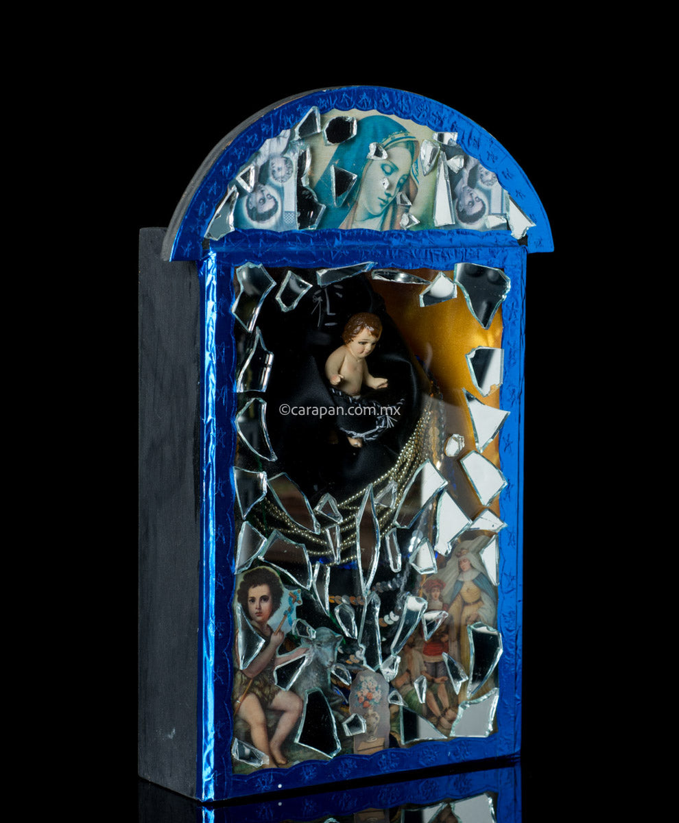 Diorama in blue with saint in black carrying baby jesus surrounded by clipping of religious images and mirror fragments. Signed 2003 By Mexican artist Alfredo Torres.