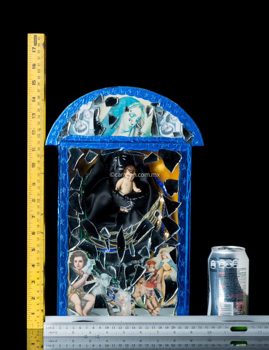 Diorama in blue with saint in black carrying baby jesus surrounded by clipping of religious images and mirror fragments. Signed 2003 By Mexican artist Alfredo Torres. 