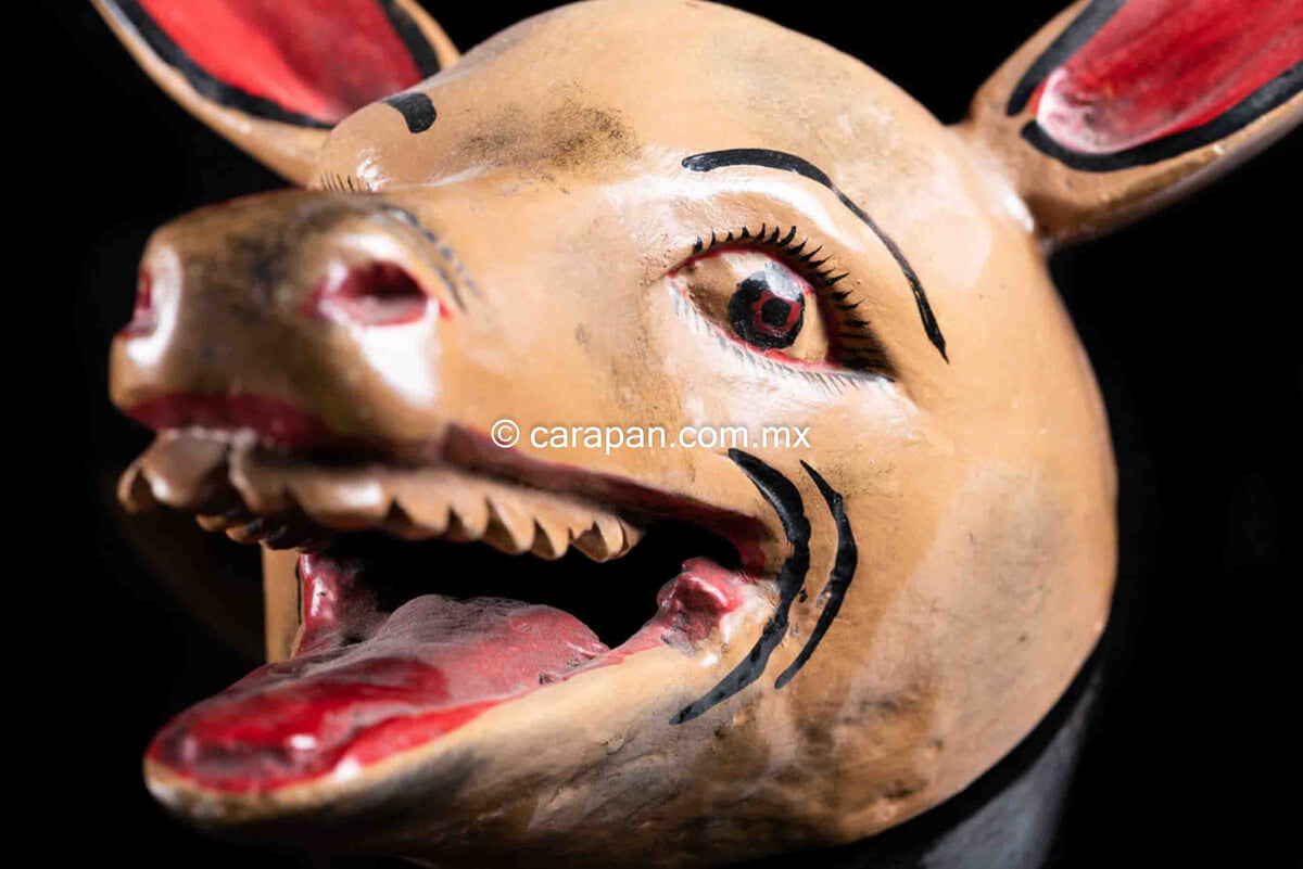 Hand carved Donkey Wood Mask Crafted in Guerrero, México. The donkey is painted in beige with its ears in red. It shows its mouth open
