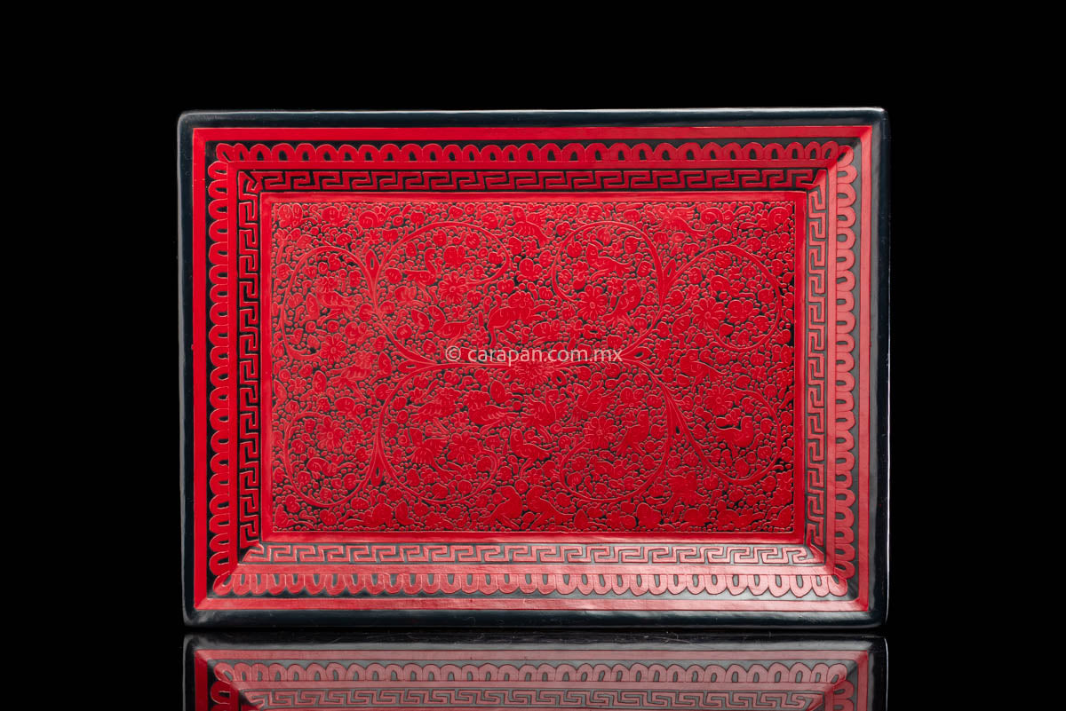 Lacquered Wood Tray in etched red over black decorated profusely with  flowers, animals and vegetal motifs the edge is framed by geometric patterns 