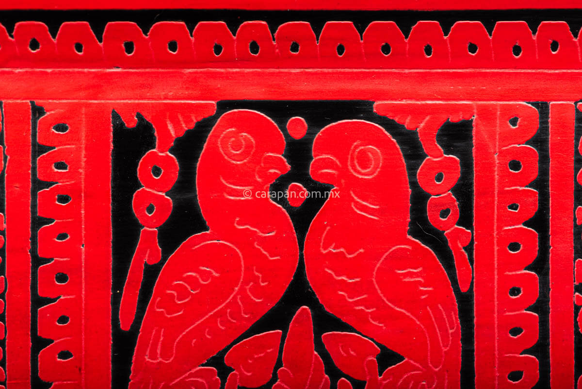 Lacquered Tray etched in red over black with three panels one with two parrots at the center and two with animals on each side