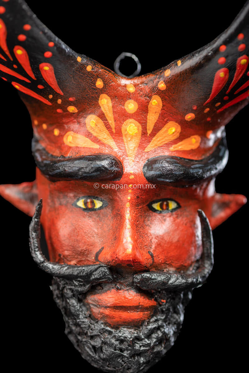Paper Mache Mask with Beard, Moustache and Curved Black Horns Painted in red with orange strokes close up