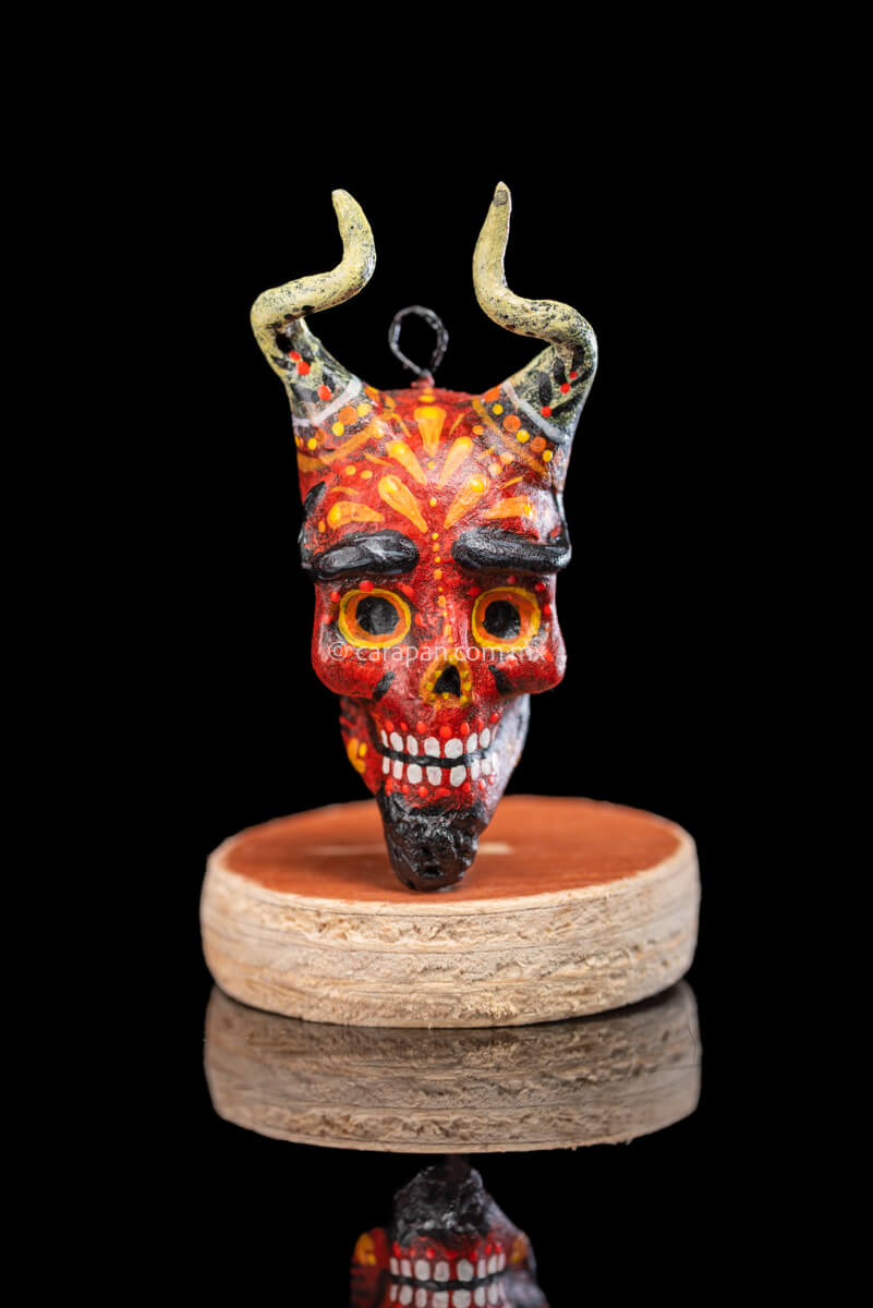 Smiling Paper Mache devil Head with White Horns Painted in red with orange strokes