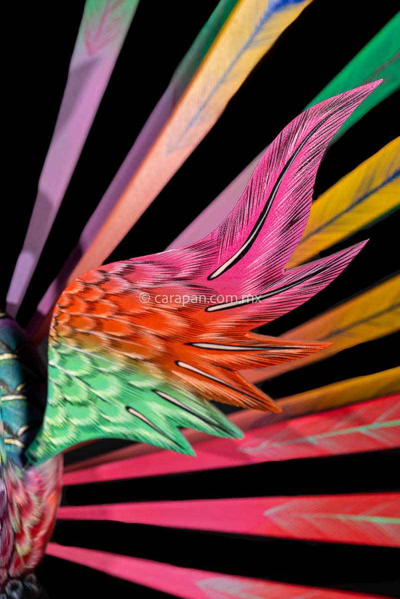 Wing detail of Peacock Wooden Sculpture Handcrafted in Oaxaca Mexico, hand painted displaying multiple colors wings& every feather are detachable 