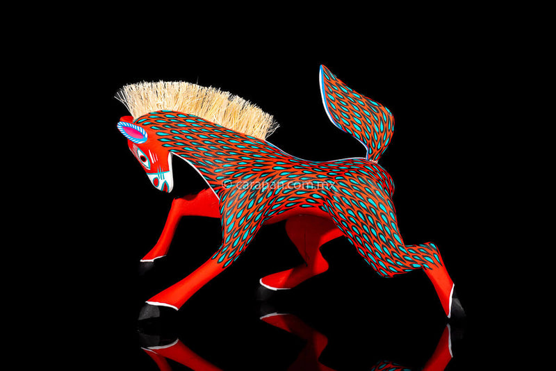 Red Horse Mexican Wood Carving Alebrije hand painted in red with green strokes. Detachable tail