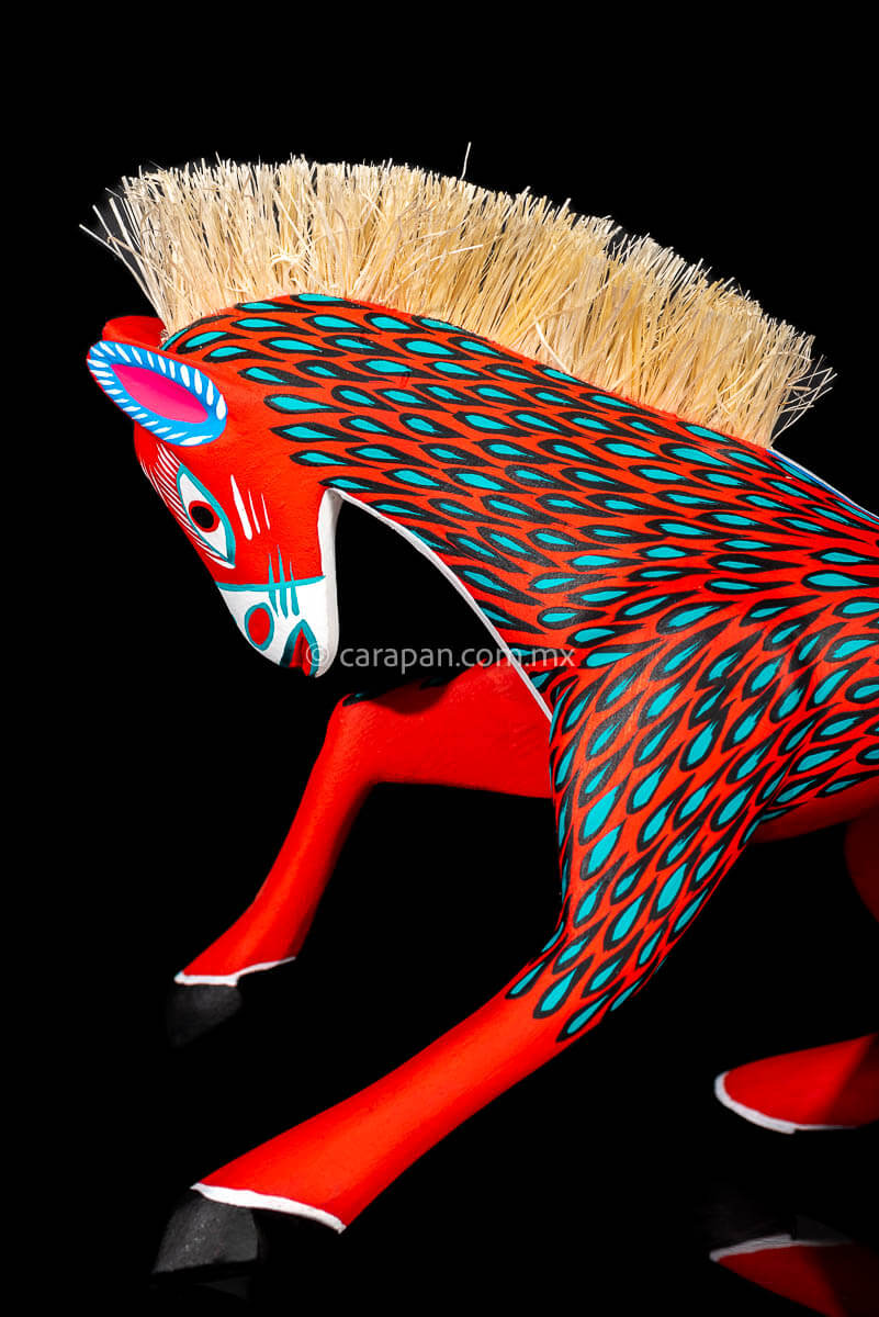 Red Horse Mexican Wood Carving Alebrije hand painted in red with green strokes. Detachable tail