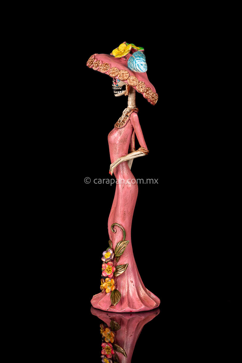 Day of the dead Sculpture, Catrina wearing a pink dress with flowers at the bottom and a traditional Posada Style hat
