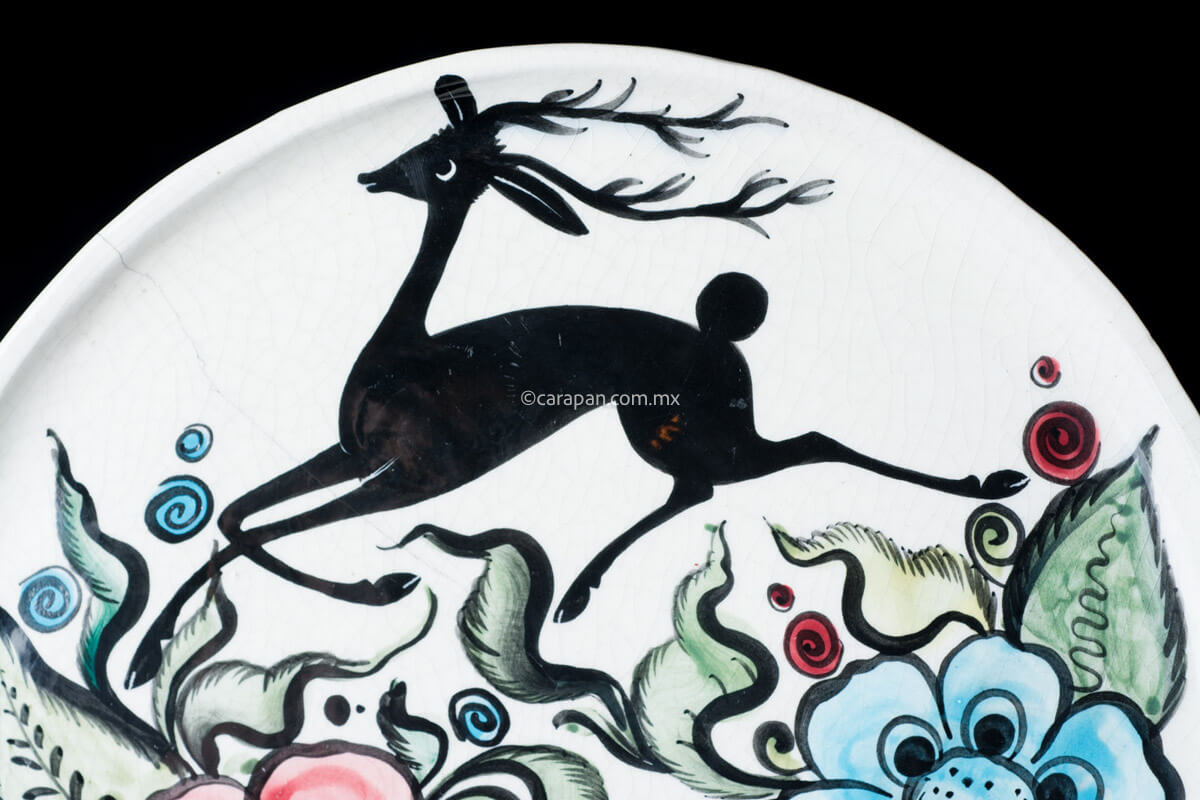 Glazed vintage dish  decorated with 3 hand painted big flowers in red, yellow & blue and a black deer on top.