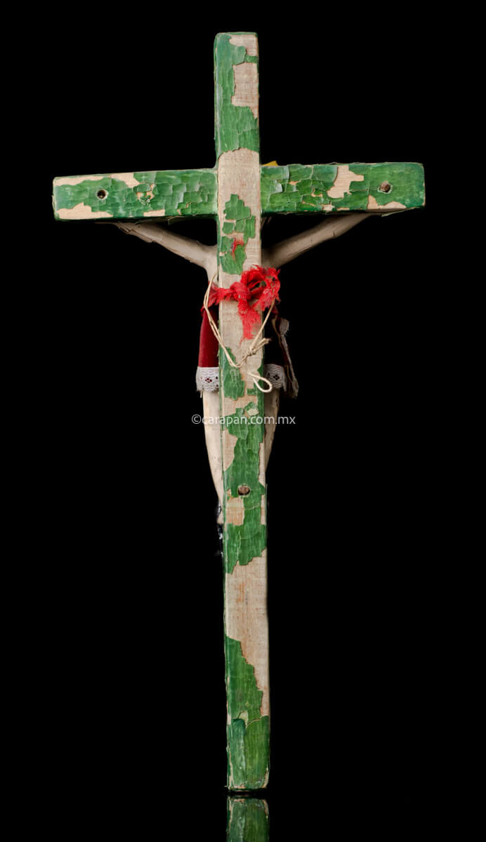 Vintage Lacquered Wood Cross with Christ Crafted in Olinalá, Guerrero. The cross is green The lacquer presents some peeled off areas. The christ wears a red cloth from the waist to his knees.  back