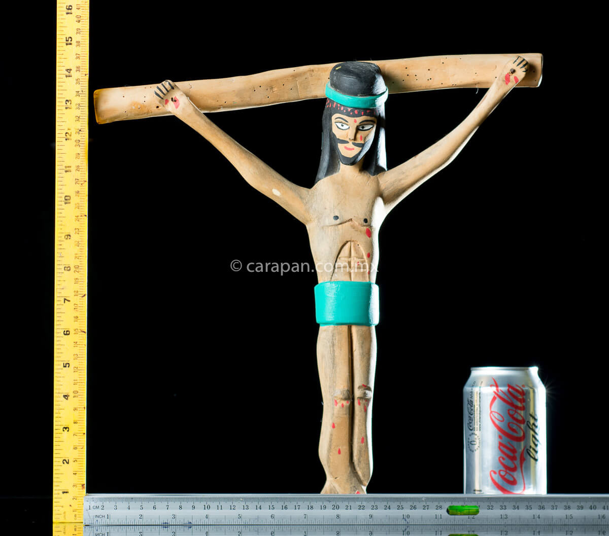 Vintage Wooden Cross Hand crafted in the 1980's in Oaxaca México. The christ in natural wood tone and only his hair and beard are painted in black as well as his loincloth and his crown, both in turquoise blue. Some blood drops are also painted in his head, handss and feet. The style is simple and naive. 