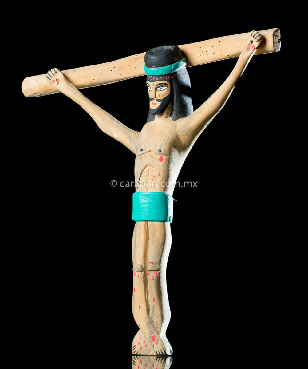Vintage Wooden Cross Hand crafted in the 1980's in Oaxaca México. The christ in natural wood tone and only his hair and beard are painted in black as well as his loincloth and his crown, both in turquoise blue. Some blood drops are also painted in his head, handss and feet. The style is simple and naive.