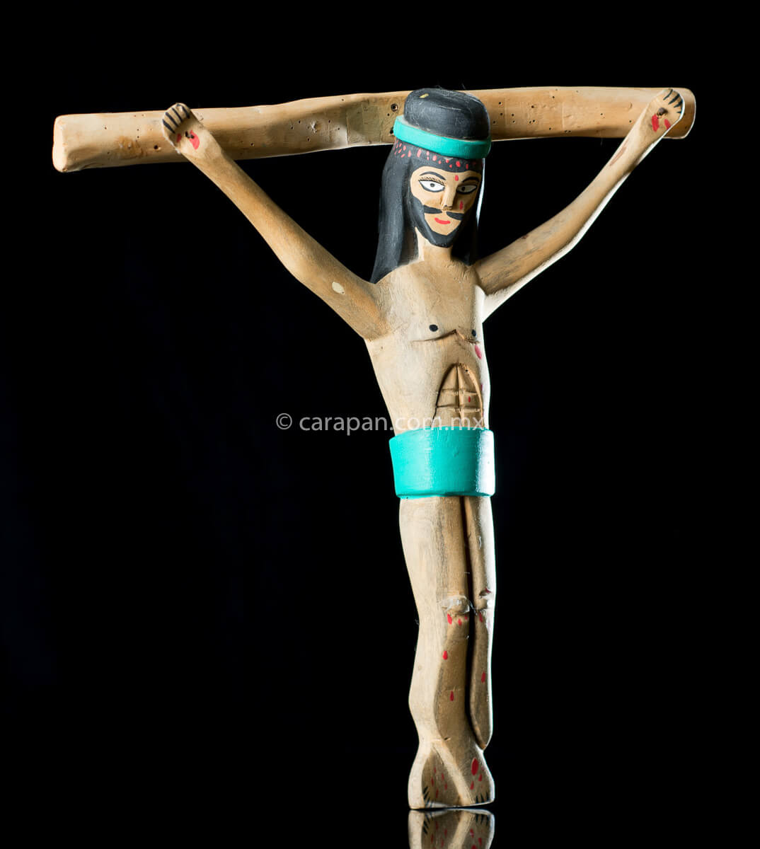 Vintage Wooden Cross Hand crafted in the 1980's in Oaxaca México. The christ in natural wood tone and only his hair and beard are painted in black as well as his loincloth and his crown, both in turquoise blue. Some blood drops are also painted in his head, handss and feet. The style is simple and naive. 