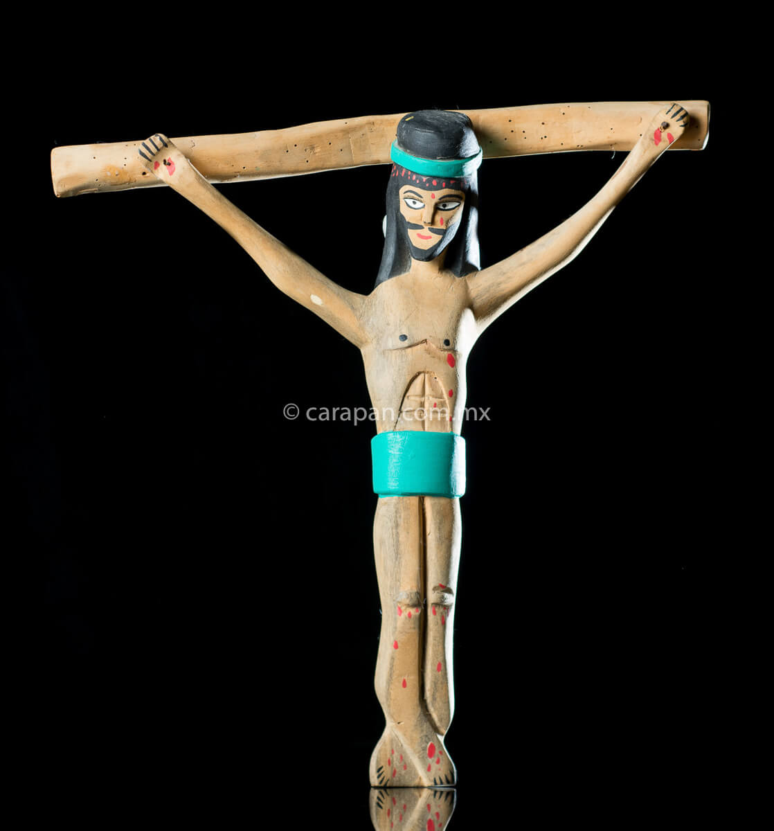 Vintage Wooden Cross Hand crafted in the 1980's in Oaxaca México. The christ in natural wood tone and only his hair and beard are painted in black as well as his loincloth and his crown, both in turquoise blue. Some blood drops are also painted in his head, handss and feet. The style is simple and naive.
