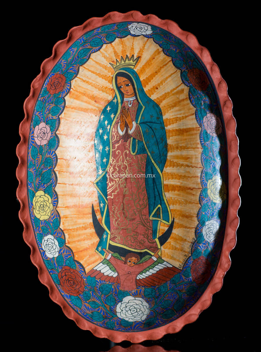 Oval Burnished Clay Medallion with Virgin of Guadalupe surrounded by flowers.