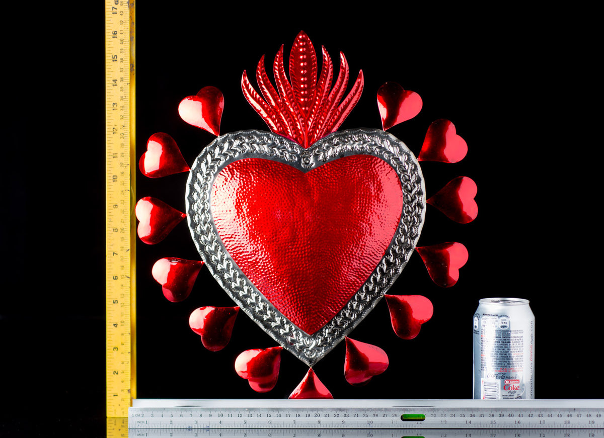 BIG RED TIN SACRED HEART SURROUNDED WITH SMALL HERATS & FLAME ON TOP ART FROM OAXACA MEXICO